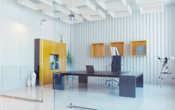 Office space with glass walls and grey and yellow furniture.