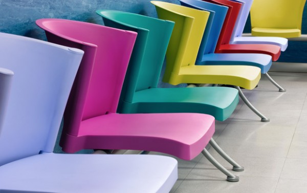 A row of chairs in different, bright colours.